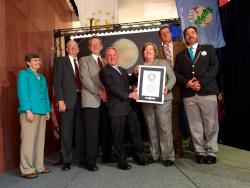 Guinness World Record Certificate Presentation for "Pluto: Not Yet Explored" Stamp